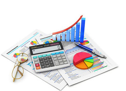 Desk calculator resting on charts print out